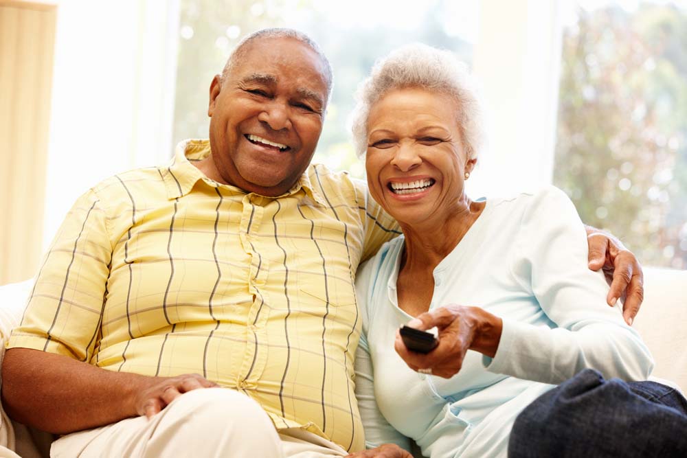 Senior African American couple watching TV